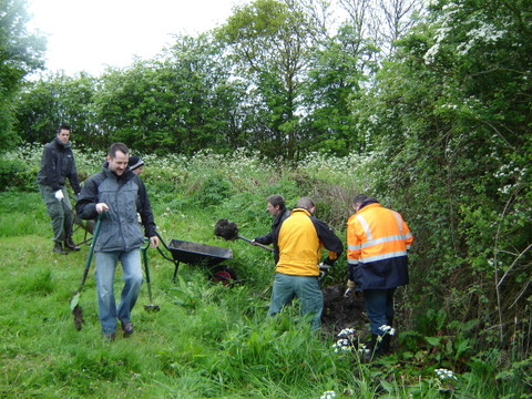 Novartis Community Partnership Day, a groups of people clearing out a ditch.