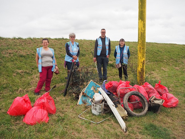 Members of East Halton RiverCare, with bags of rubbish cleaned from the river.