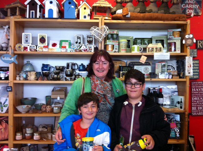 Group of smiling people in a gift shop.